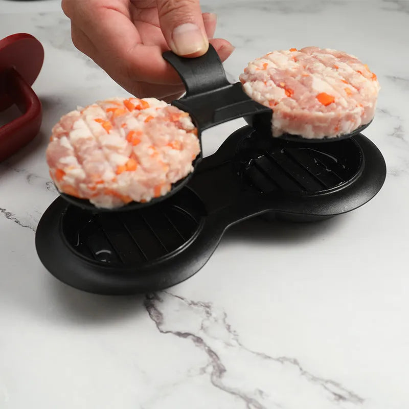 Black and red round burger press with non-stick surface and oil paper liners.