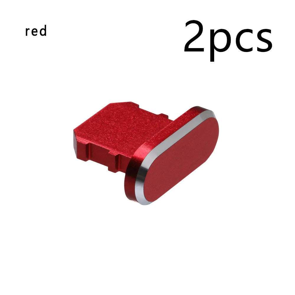 Aluminium alloy iPhone charging port dust plug in various colours on a dark background