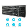 Ultra-thin white rechargeable Bluetooth keyboard next to a tablet, showing its 104-key layout and slim profile.