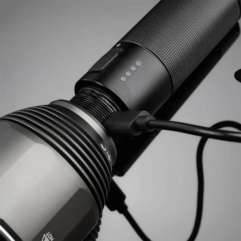 Black aluminium rechargeable flashlight showing scale with 2000 lumen output and type-C charging port