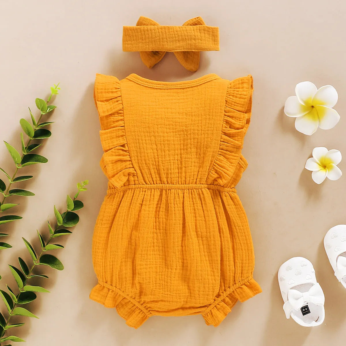 Baby girl cotton triangle romper with lace sleeves and ruffled trim in green colour, includes headwear