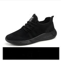 Men's black and white breathable mesh sneakers with lace-up closure and PVC sole