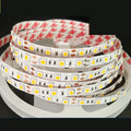 Close-up of a flexible white LED light strip showing 2835 and 5050 chip types for shelf lighting.