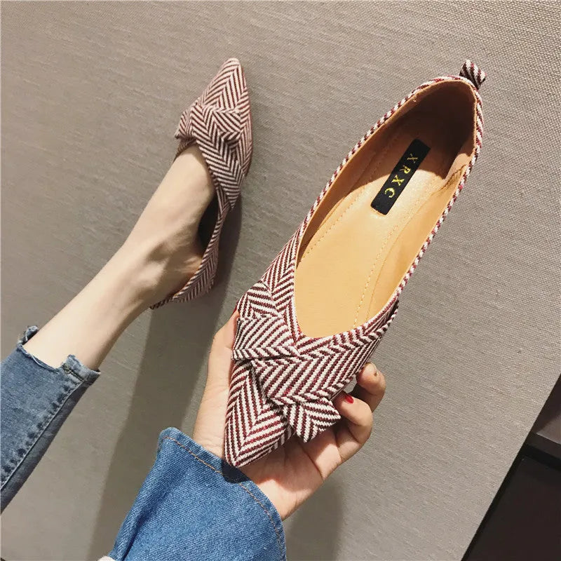 Women's black and red pointed toe shallow mouth casual shoes with a low flat heel.