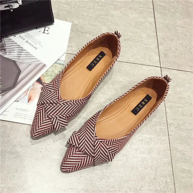 Women's black and red pointed toe shallow mouth casual shoes with a low flat heel.