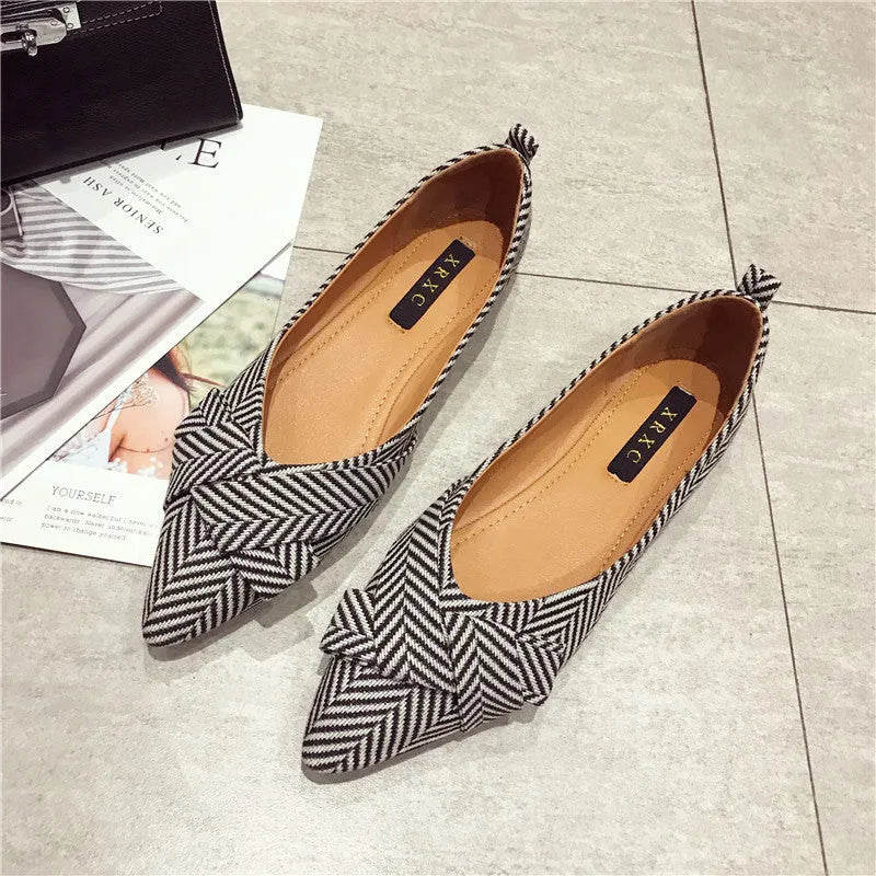 Women's black and red pointed toe shallow mouth casual shoes with a low flat heel.