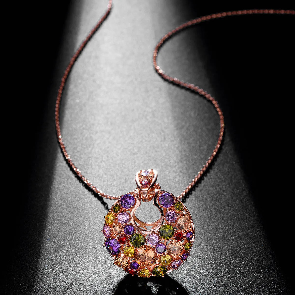 Geometric copper pendant necklace with clear zircon stones, rose gold electroplated finish, on display