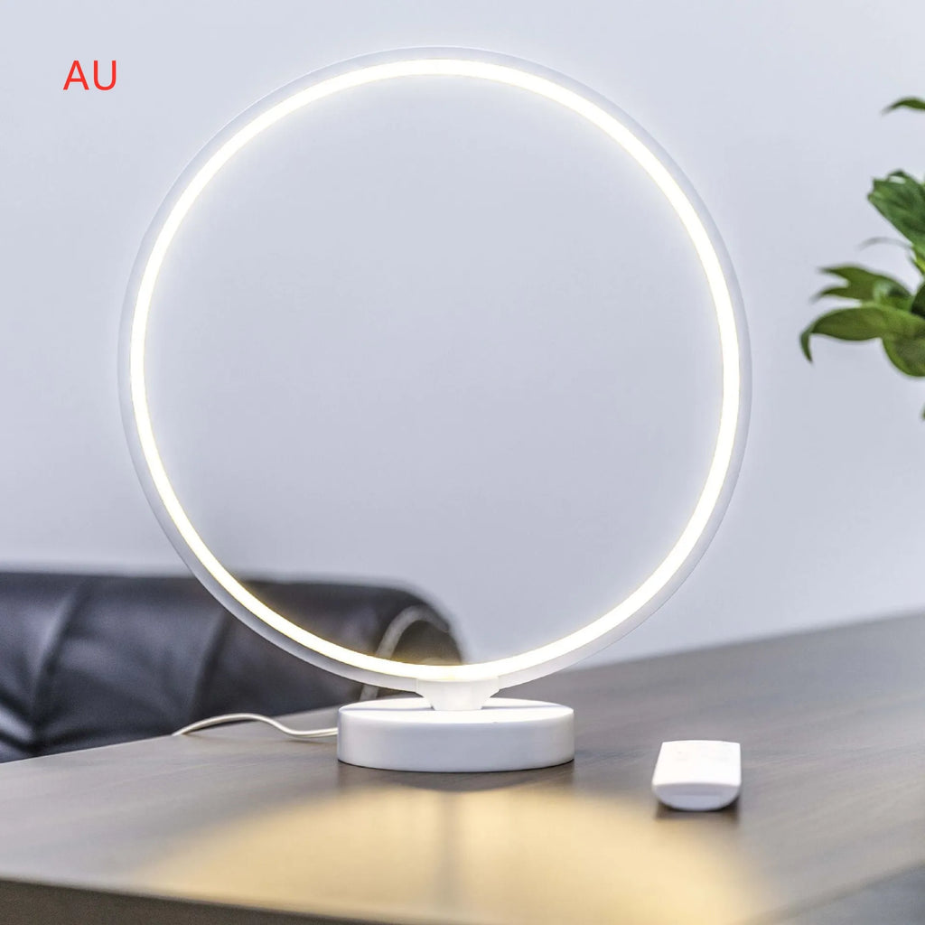 White Full Moon Mood Lamp on table with remote control showing colour-changing and warm white lighting modes
