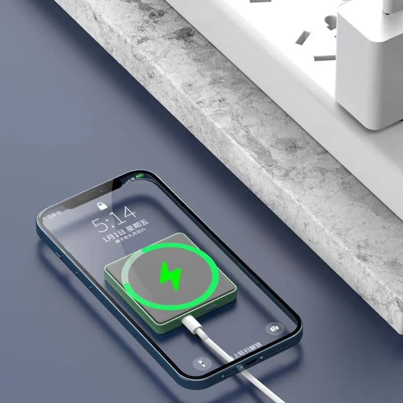 Mini magnetic wireless power bank in blue, displaying 5000mAh capacity and USB ports on a neutral background