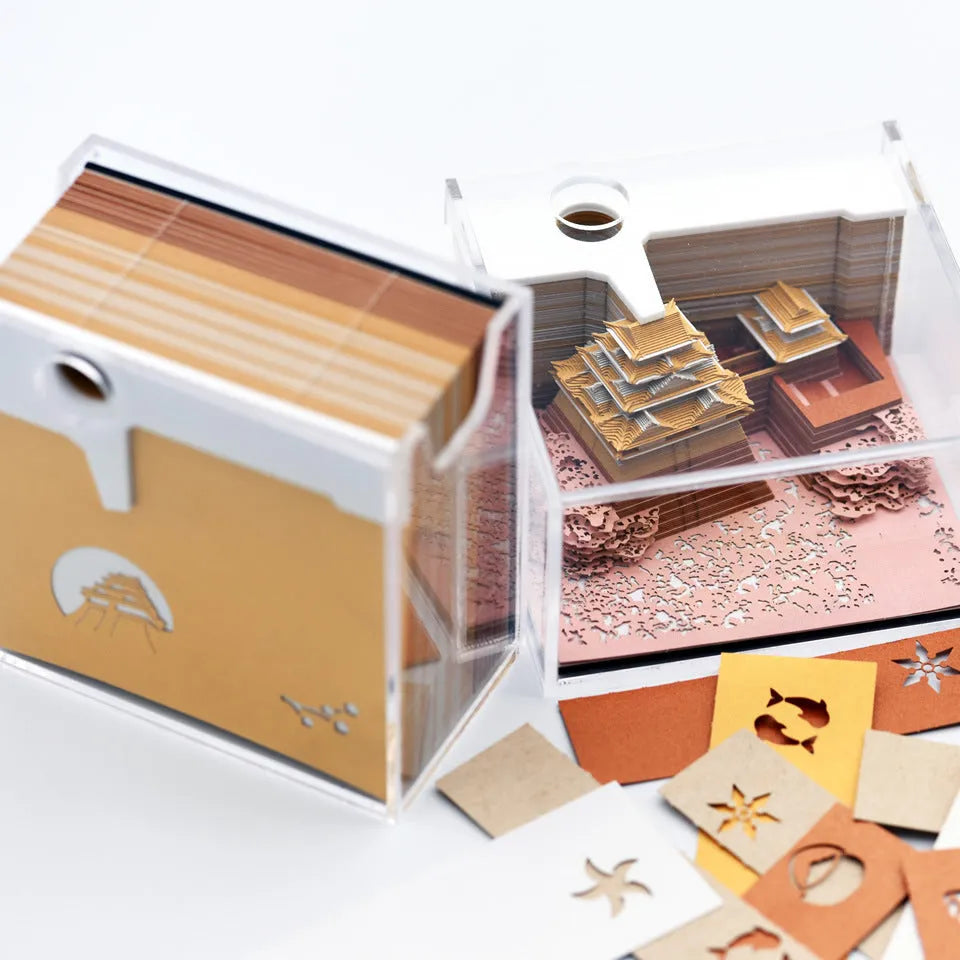 3D paper architectural model of the Tianshou Tower from Spirited Away, shown in gold, pink, and white colour options.