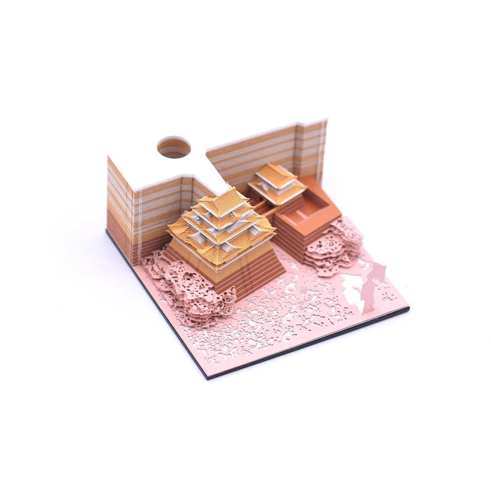 3D paper architectural model of the Tianshou Tower from Spirited Away, shown in gold, pink, and white colour options.