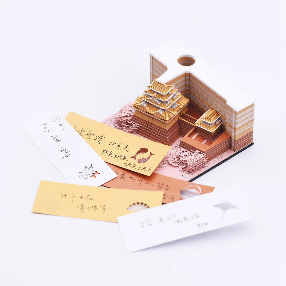 3D paper architectural model of the Tianshou Tower from Spirited Away, shown in gold, pink, and white colour options.