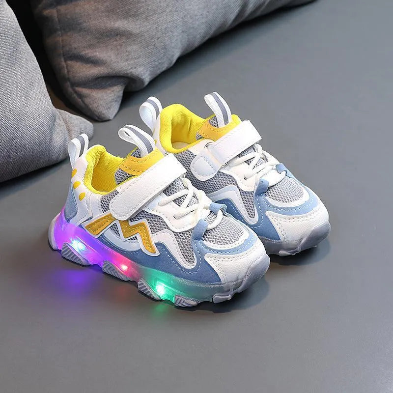 Kids black mesh sneakers with Velcro strap on a light rubber sole