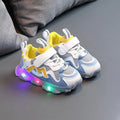 Kids black mesh sneakers with Velcro strap on a light rubber sole