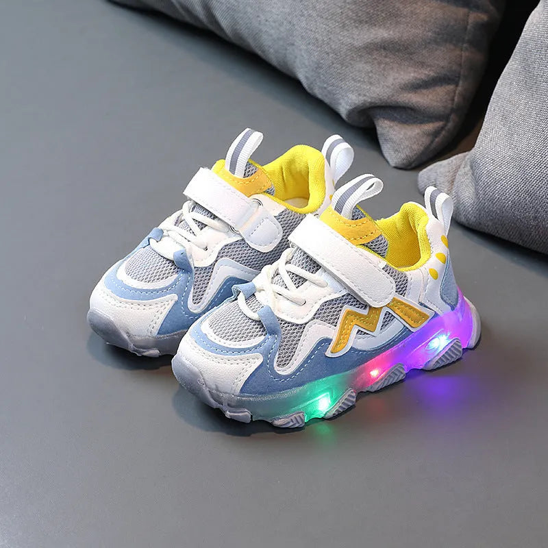 Kids black mesh sneakers with Velcro strap on a light rubber sole