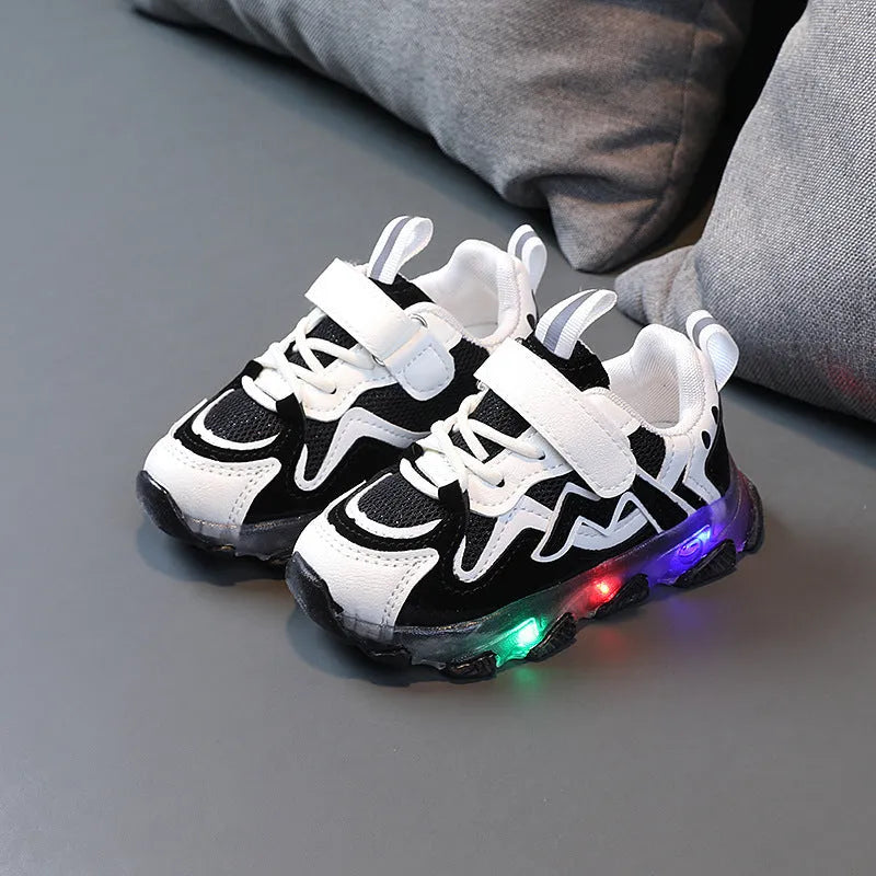 Kids black mesh sneakers with Velcro strap on a light rubber sole