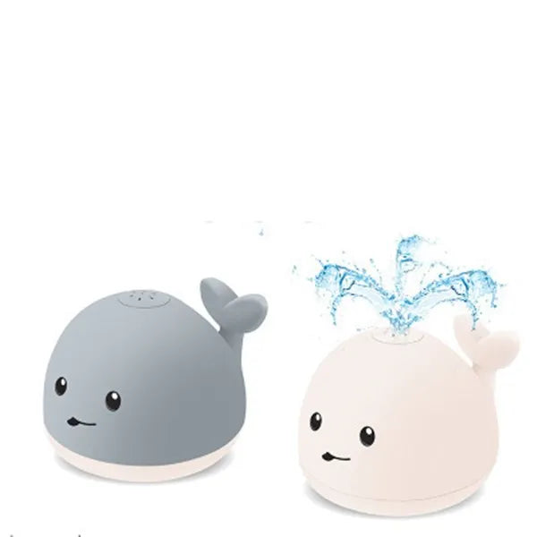Floating grey and white whale bath toy spraying water with LED lights