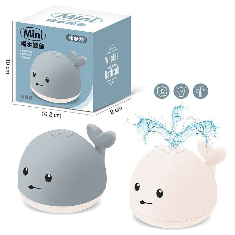 Floating grey and white whale bath toy spraying water with LED lights