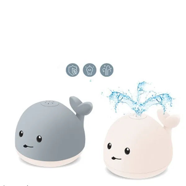 Floating grey and white whale bath toy spraying water with LED lights