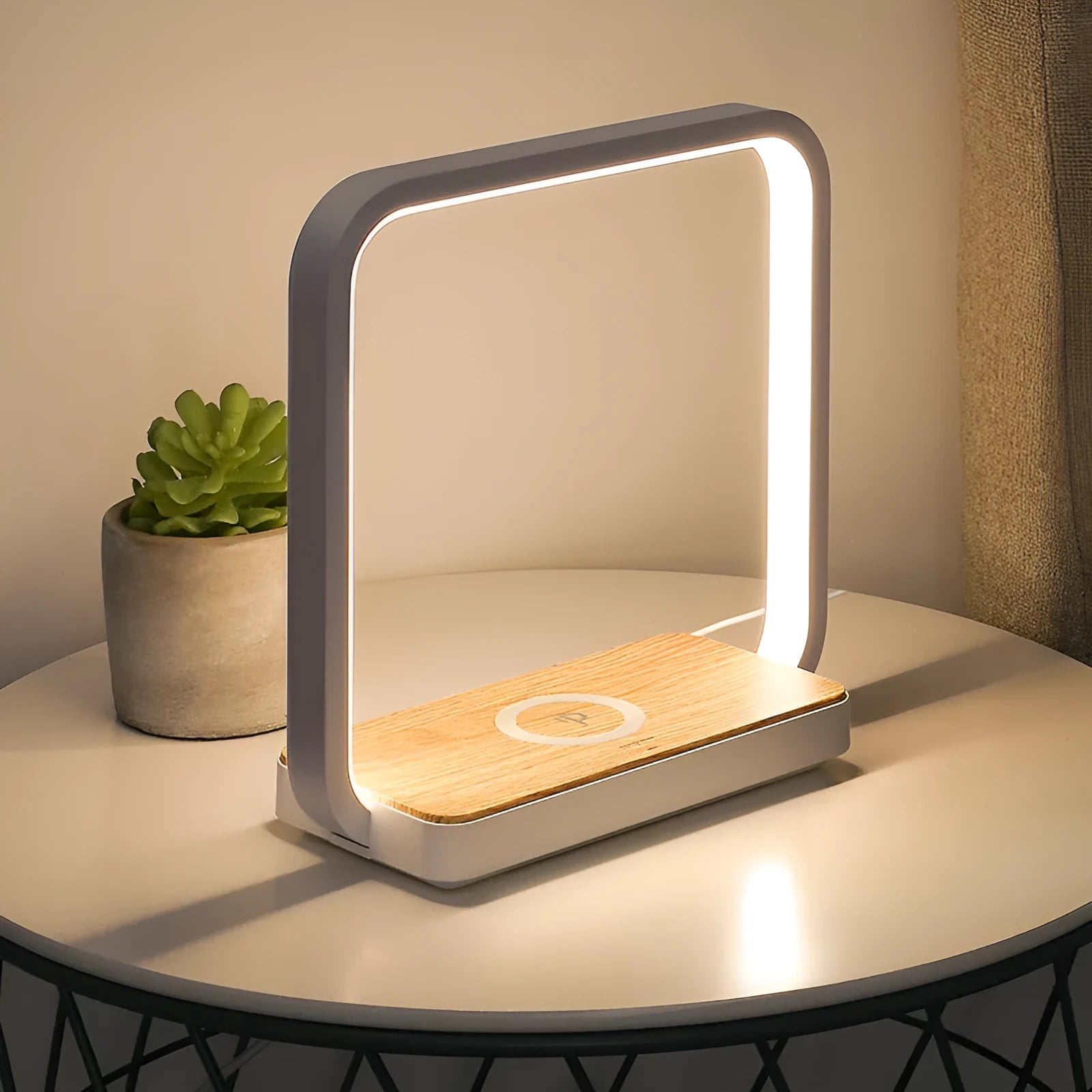 Modern white smart bedside lamp with touch control and USB cable on a wooden nightstand.