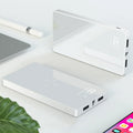 Black wireless power bank with digital display showing battery percentage and two USB charging ports