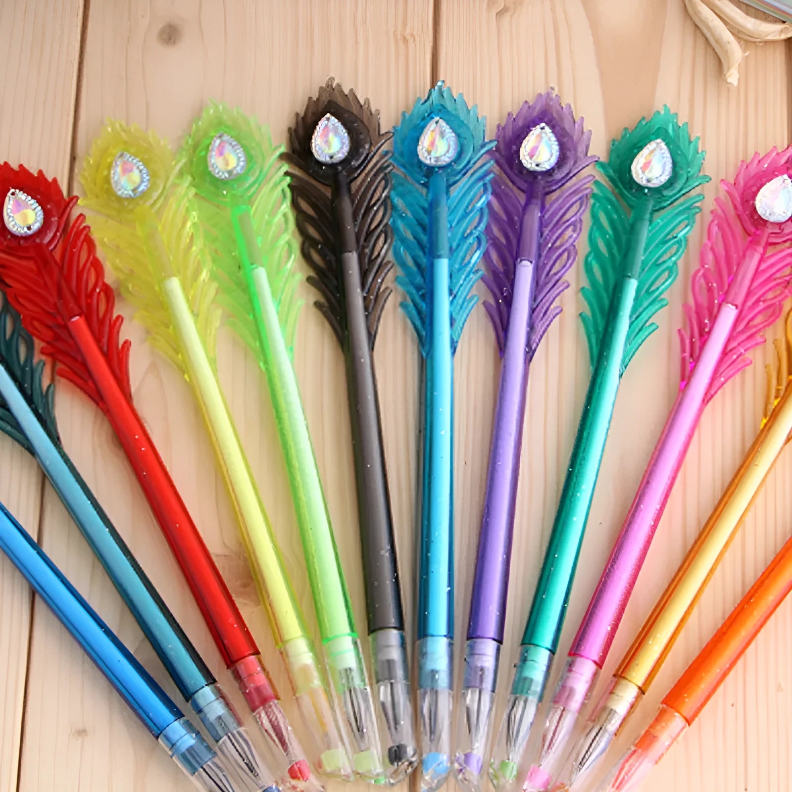 Cute feather peacock colour gel pen set with 12 different coloured pens showing 0.5mm tips