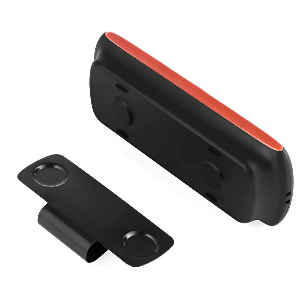 Orange plastic Bluetooth hands-free car speaker kit mounted on a sun visor.