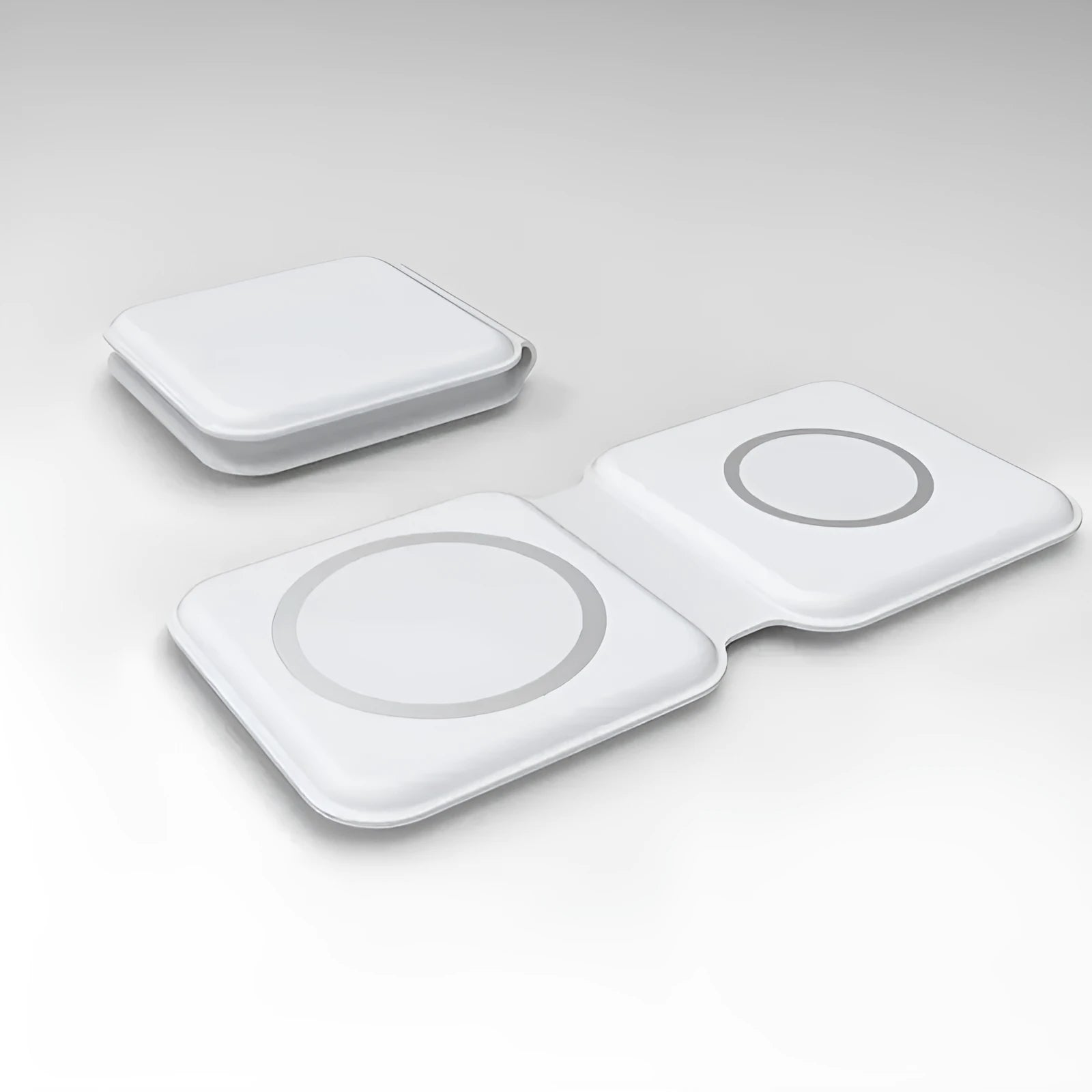 White foldable magnetic wireless charging dock with a phone attached and earbud case on the base.