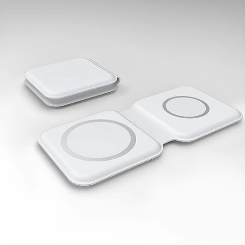 White foldable magnetic wireless charging dock with a phone attached and earbud case on the base.
