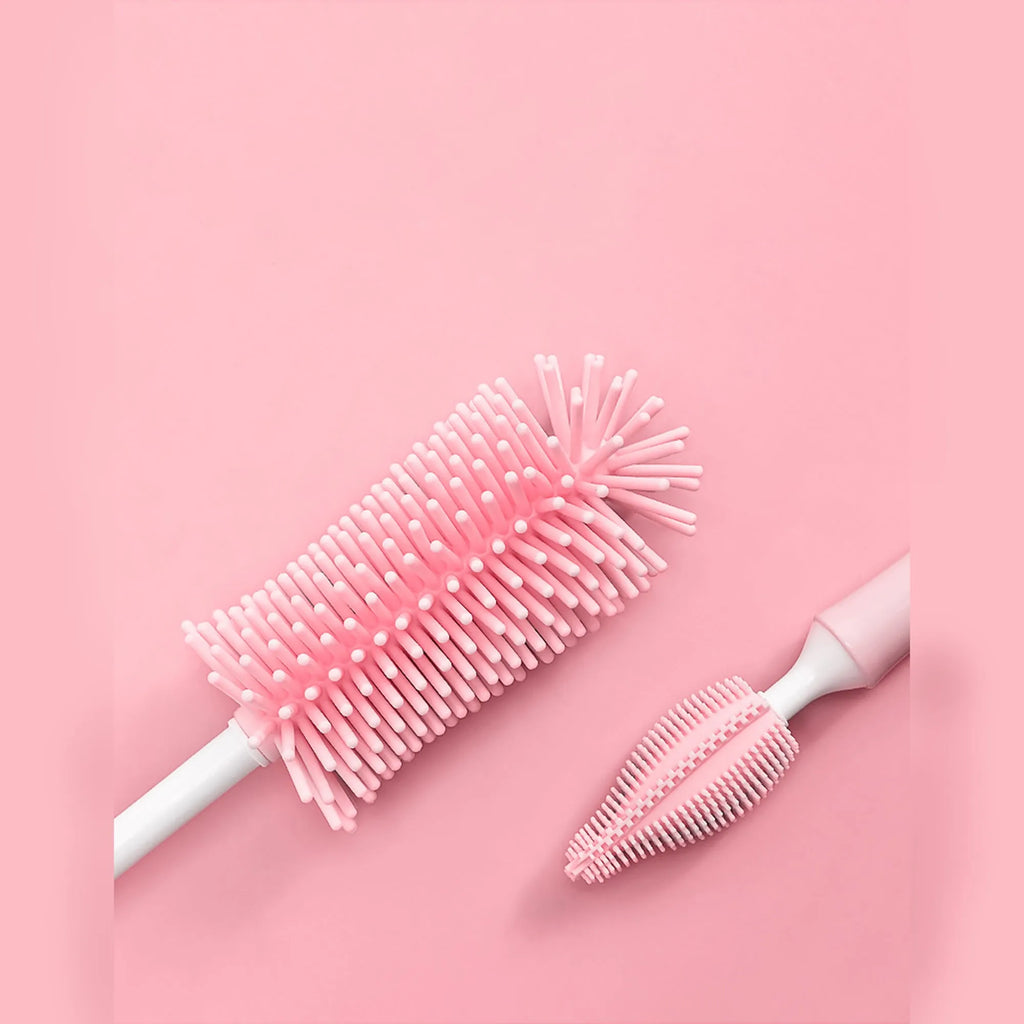 Three silicone baby bottle brushes in pink, blue, and yellow colours including a straw cleaning brush.