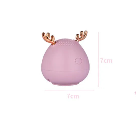Compact wireless Bluetooth speaker with USB cable in green, pink, or white colour options