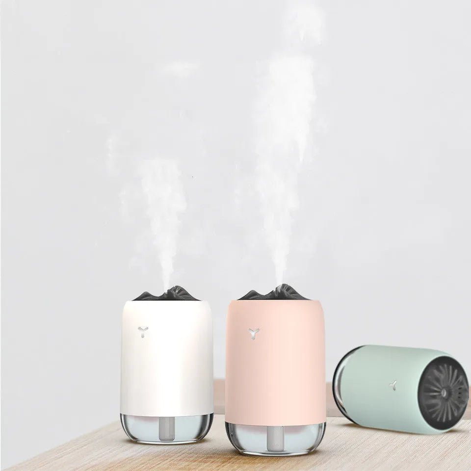 Magic Flame columnar USB humidifier in light blue, pink, or white colours for desktop use
