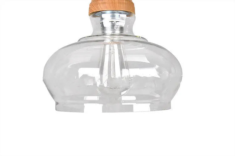 Nordic style single head pendant light with wood grain glass shade on adjustable cable.