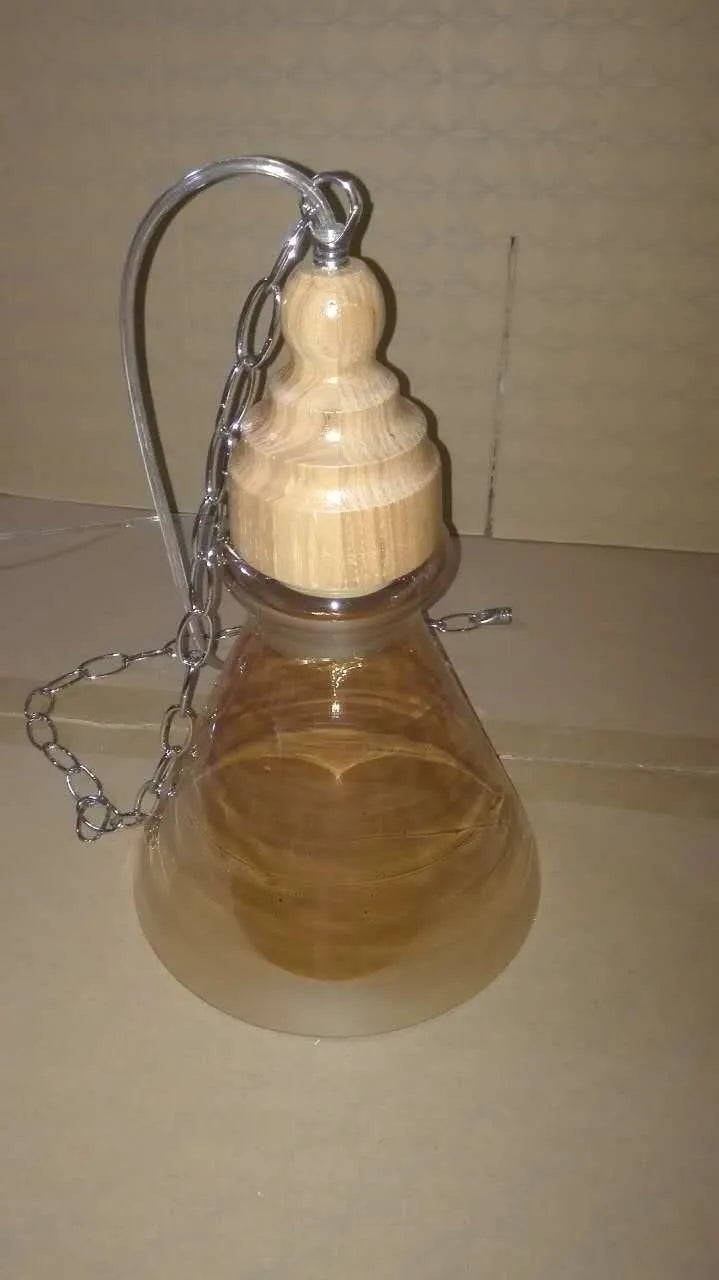 Nordic style single head pendant light with wood grain glass shade on adjustable cable.
