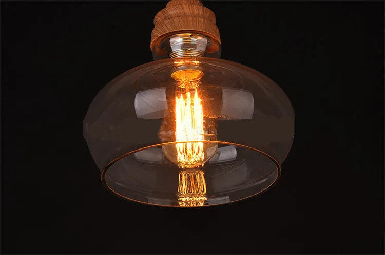 Nordic style single head pendant light with wood grain glass shade on adjustable cable.