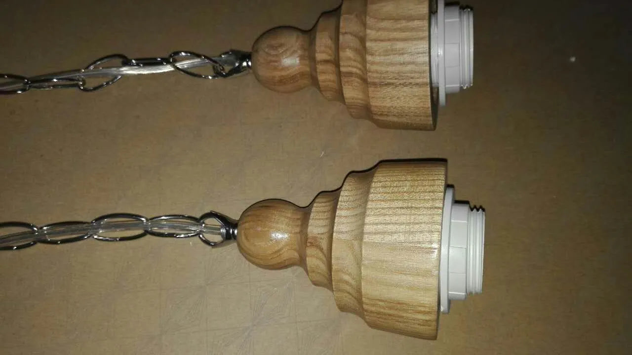 Nordic style single head pendant light with wood grain glass shade on adjustable cable.