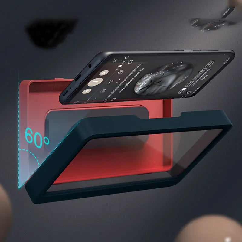 White adhesive waterproof phone holder mounted on a bathroom tile wall holding a mobile phone.