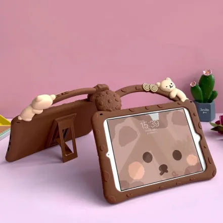 Brown cartoon-style silicone sleeve with a fold-out bracket stand for an iPad tablet.