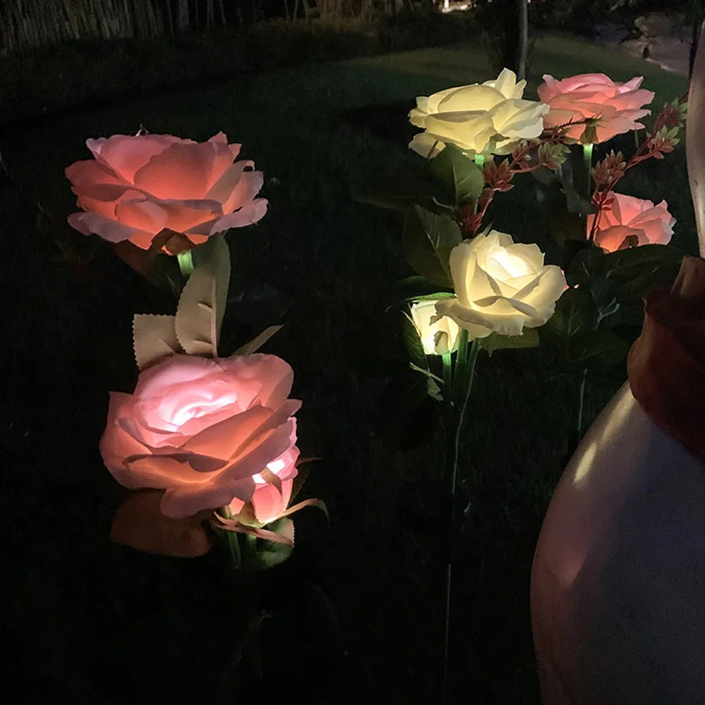 Outdoor solar rose lawn lamp with three rose heads, ground spike installation, and silk cloth petals