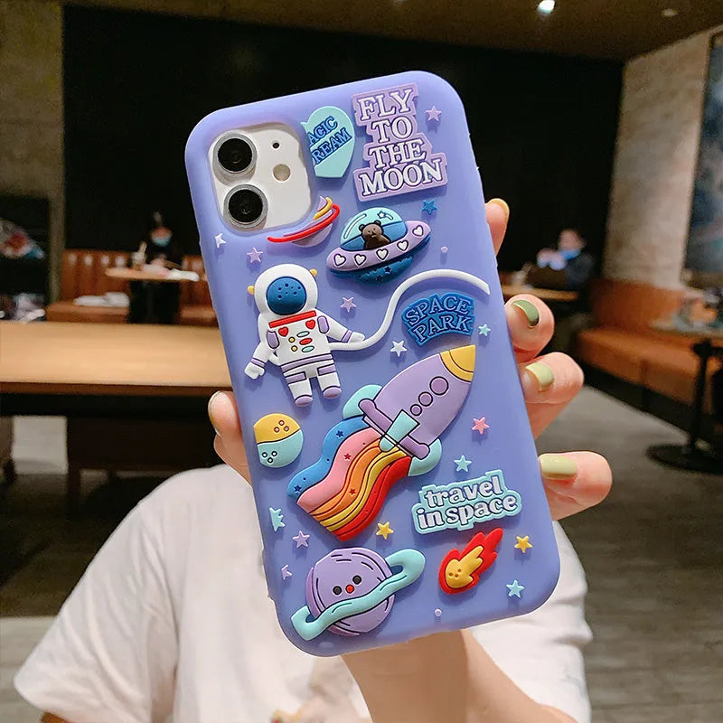 Purple silicone iPhone case with a detailed cartoon astronaut design on the back.