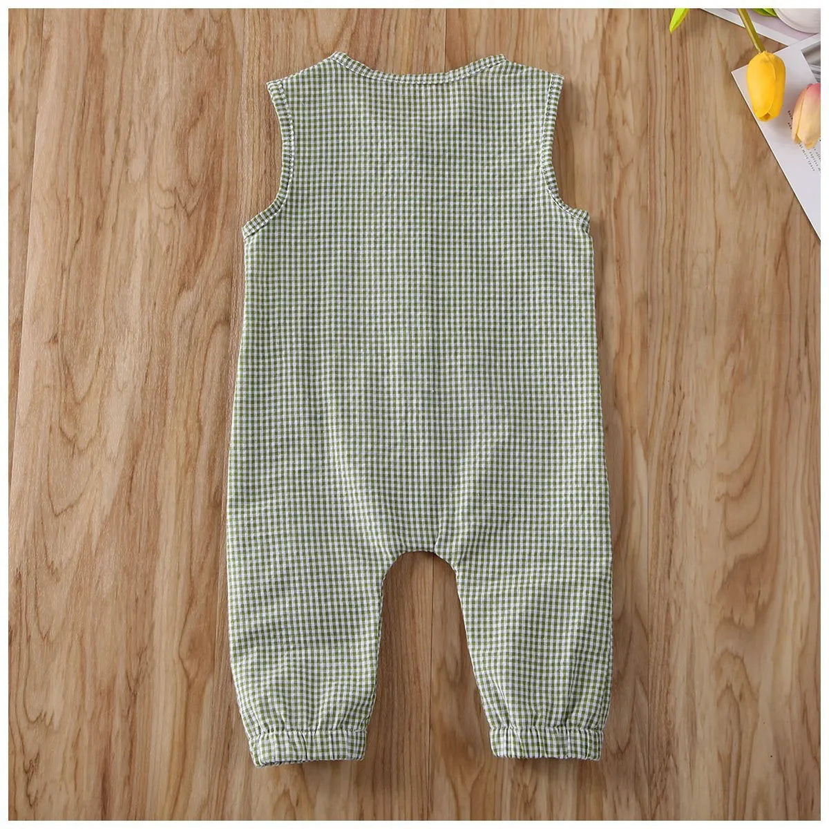 Black baby romper with lid buckle closure and sleeveless cotton design for newborns