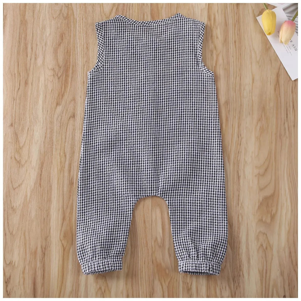 Black baby romper with lid buckle closure and sleeveless cotton design for newborns