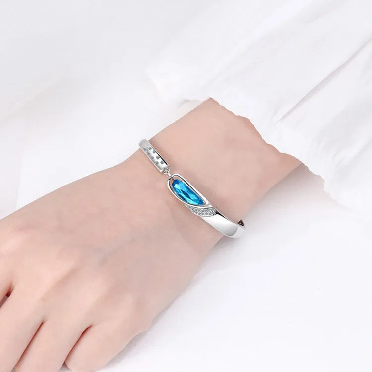 Silver-plated heart pendant necklace with blue crystal zircon inlay on display