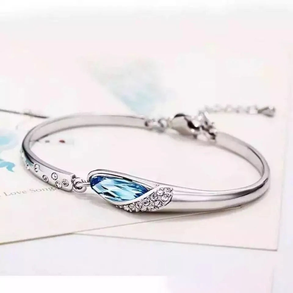 Silver-plated heart pendant necklace with blue crystal zircon inlay on display
