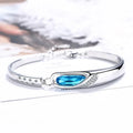 Silver-plated heart pendant necklace with blue crystal zircon inlay on display