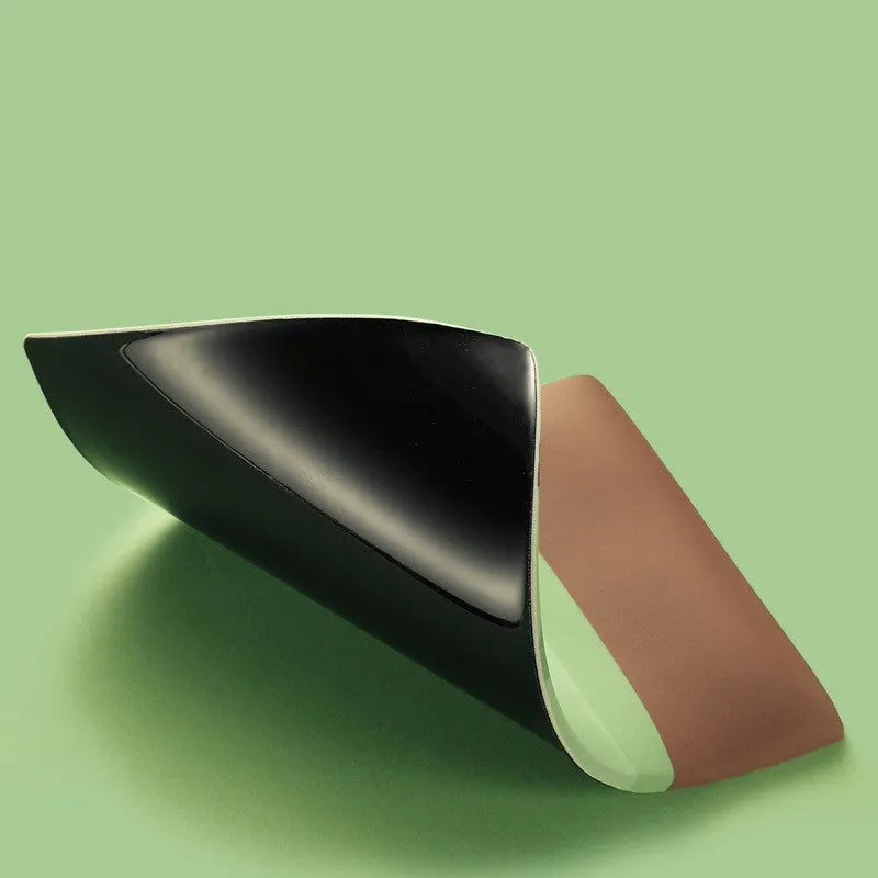 A soft, thickened wrist mouse pad with a printed graphic, shown on a desk.