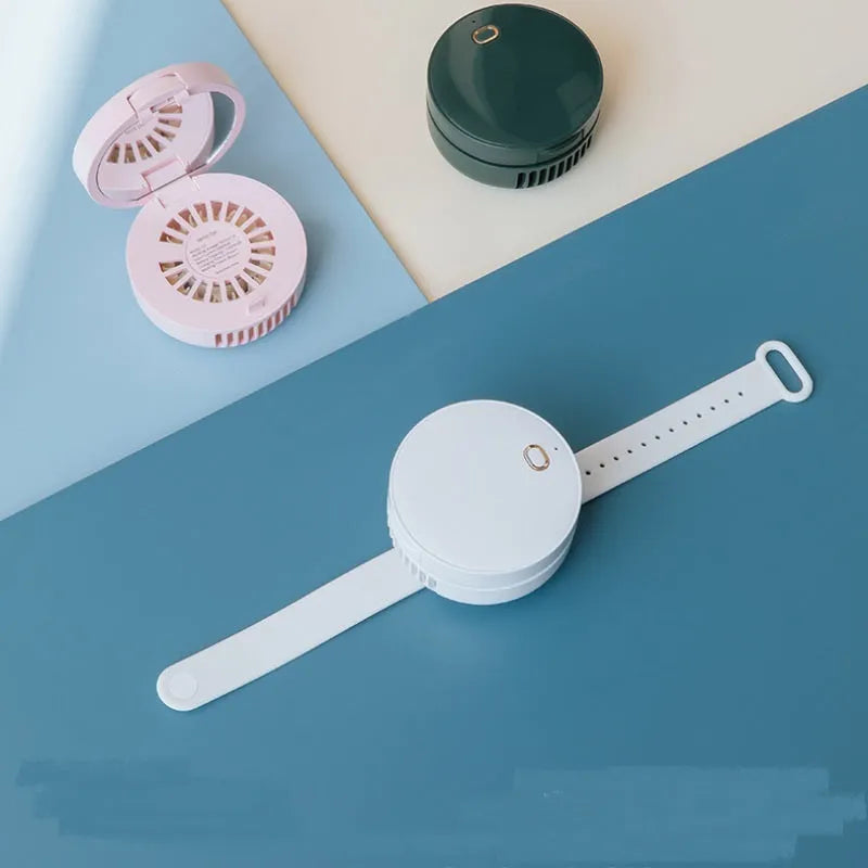 Portable leafless wrist fan with mirror, USB rechargeable, three speed settings, 66x41mm, in white on a table