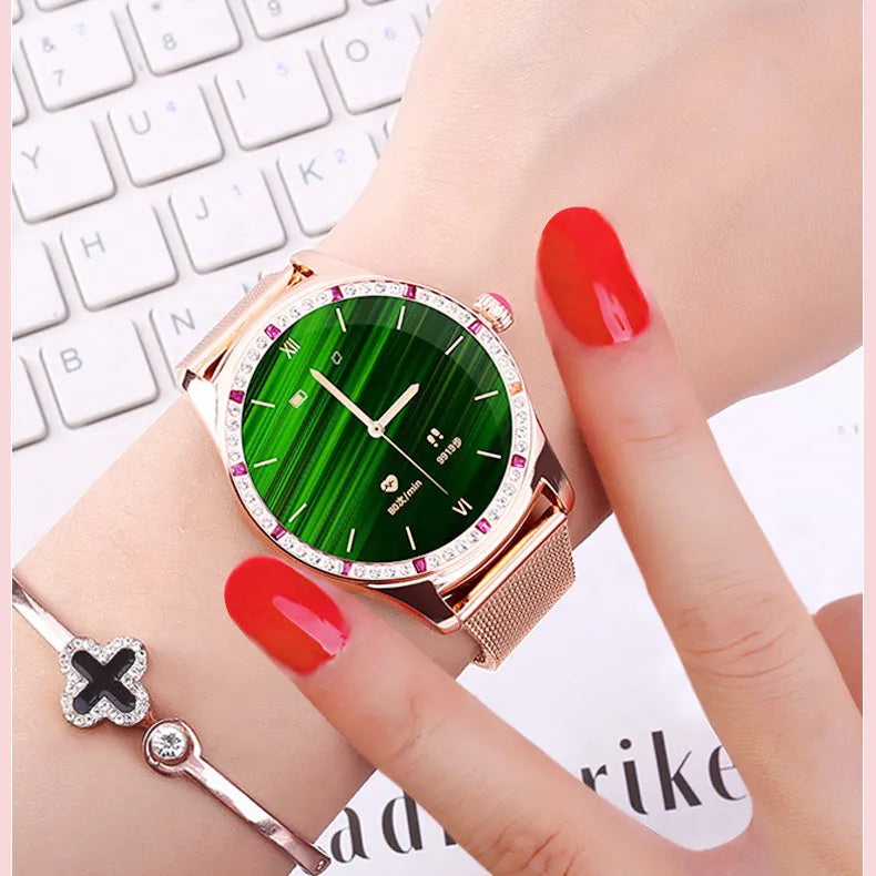Gold and silver ladies smart watch with a 1.28-inch screen on a wristband, showing Bluetooth calling and health monitoring interface.
