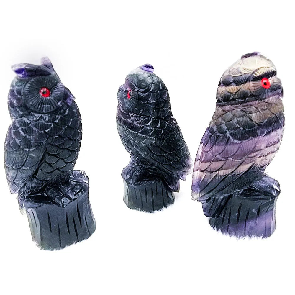 Hand carved purple fluorite owl ornament showing detailed carving and natural colour variation