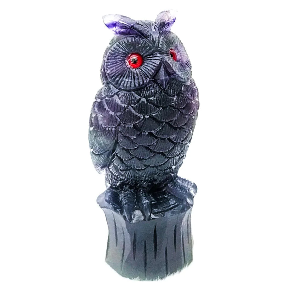 Hand carved purple fluorite owl ornament showing detailed carving and natural colour variation